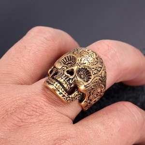 Macro shot of retro bronze skull ring with intricate Mexican Day of the Dead carvings