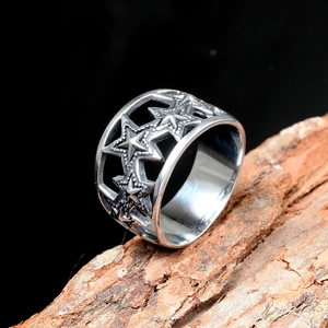 Close-up of geometric star cut-outs on a vintage stainless steel ring with beaded edges