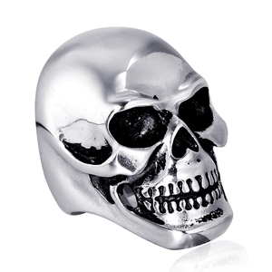 Polished stainless steel skull ring with vintage blackened Gothic details on white background