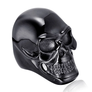 Polished stainless steel skull ring with matte black finish in a 45-degree angle view