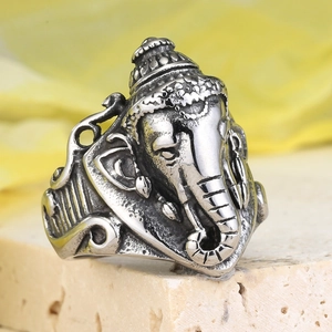 Macro detail of vintage stainless steel Ganesha ring with embossed antique silver finish