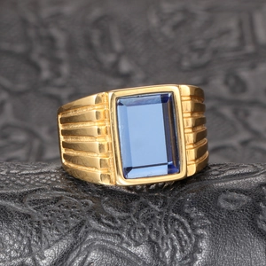 Macro detail of men's titanium ring with rectangular blue gemstone and ribbed texture