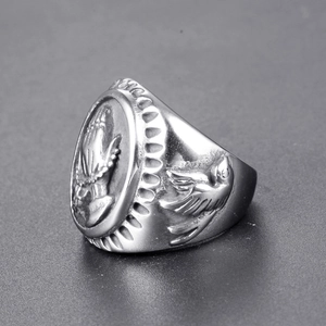 Macro view of vintage silver steel ring featuring praying hands and dove relief