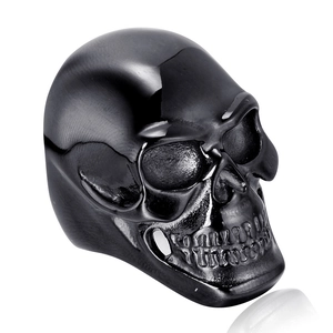 Gothic black stainless steel skull ring with polished and matte finish on white background