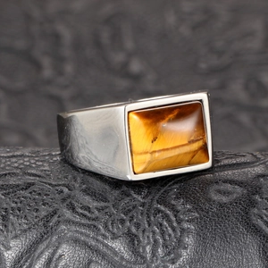 Men's titanium steel ring with rectangular tiger eye stone on black leather background