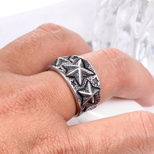 Detailed view of men's vintage steel ring featuring embossed stars and punk aesthetic