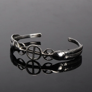 Vintage stainless steel open bangle with eagle feather design and medicine wheel symbol