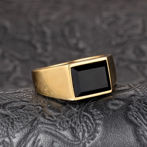 Men's geometric gold titanium steel ring with rectangular black onyx on leather surface
