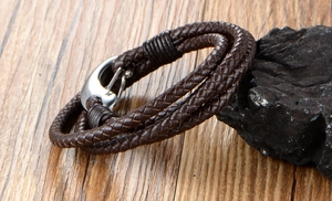 Detailed view of dark brown multilayer braided leather bracelet with silver anchor clasp