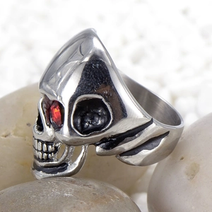 Close-up of gothic skull ring with red eye gemstone detail and vintage steel finish