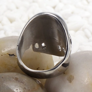 Macro shot of the inner hollow structure and brushed metal texture of the skull ring