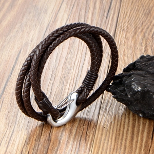 Multilayer dark brown braided leather bracelet with silver anchor hook clasp on wood