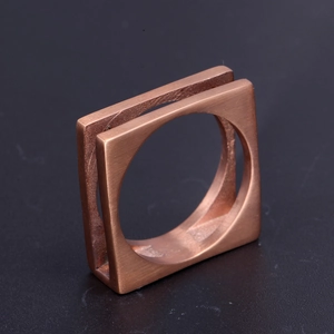 Macro detail of men's square stainless steel ring with brushed metal finish