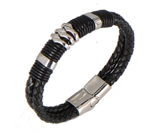 Detail of woven black leather bracelet with silver wave patterns and polished clasp