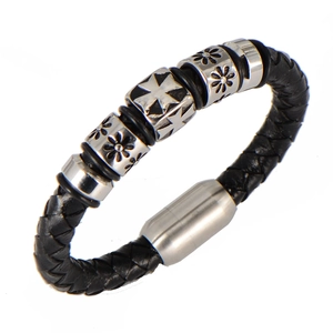 Detail of woven black leather bracelet with silver cross and metal decorative beads