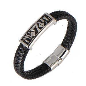 Detailed macro view of black braided leather bracelet with stainless steel magnetic clasp