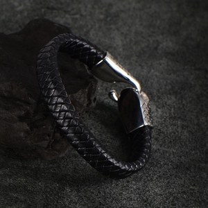 Close-up of black braided leather men's bracelet with detailed silver metal hook clasp