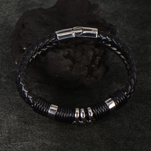 Men's braided black leather bracelet with silver magnetic clasp and metal ring charms
