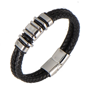 Detail of black braided leather bracelet with stainless steel magnetic clasp and metal rings