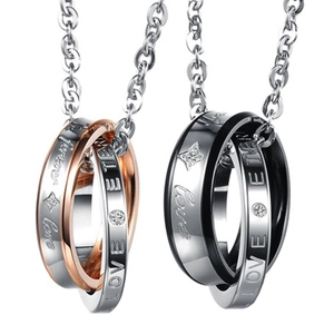 Macro detail of interlocked double ring pendants with Forever Love engravings