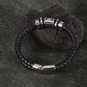 Men's black braided leather bracelet with silver stainless steel rings and magnetic clasp