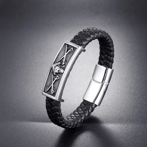Men's black braided leather bracelet with silver skull charm and magnetic clasp