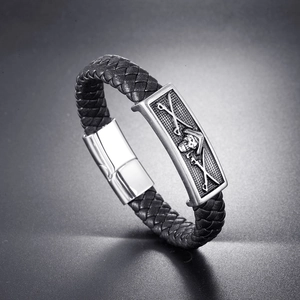 Braided black leather pirate bracelet with silver skull charm and magnetic clasp