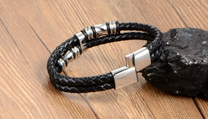 Detail of men's double-layer braided leather bracelet with silver magnetic metal clasp