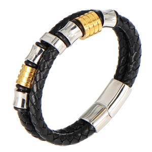Detail of double-layer braided leather bracelet with magnetic metal clasp and metal charms