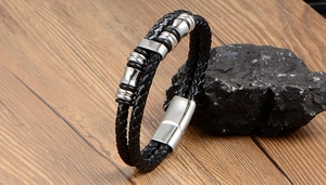 Close-up of double-strand braided leather bracelet with magnetic steel clasp on stone