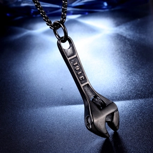 Macro detail of 316L stainless steel engraving on gunmetal wrench pendant necklace