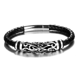 Macro shot of men's braided black leather bracelet with engraved silver metal tube detail