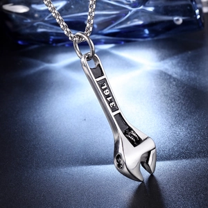 Macro detail of wrench pendant in 316L stainless steel with steel square pearl chain