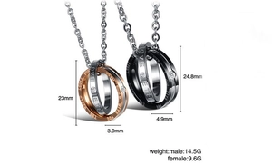 Detail of interlocking couple necklace pendants with Love Eternal engraving and crystals