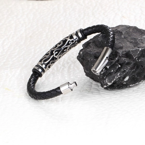 Men's woven leather punk bracelet with silver carved metal centerpiece on black stone