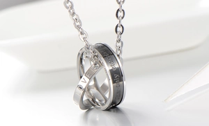 Detailed macro view of interlocking couple's rings pendant with eternal love engraving