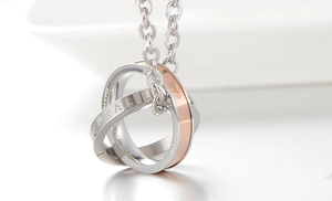 Macro view of interlocking silver and rose gold rings with Eternal Love engraving