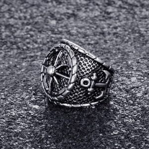 Vintage stainless steel nautical ring featuring a detailed ship wheel and anchor design