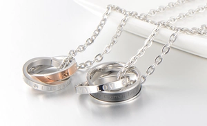 Close-up of interlocking S925 silver rings with Eternal Love engraving and crystals