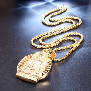 Macro view of gold stainless steel Buddha pendant with intricate relief and box chain detail