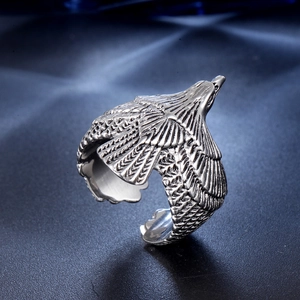 Macro shot of retro steel eagle ring showing detailed carved wing textures and feathers