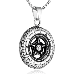 Macro shot of silver tire-shaped pendant with intricate wheel rim texture on steel chain