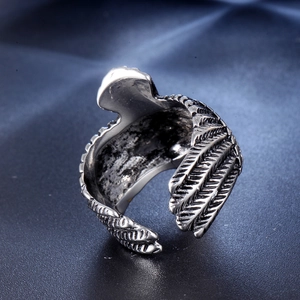 Macro view of vintage eagle wing ring showing fine feather textures and oxidized steel