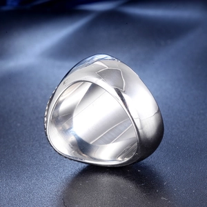 Macro view of wide silver polished stainless steel ring band for men with punk style finish