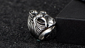 Detailed close-up of a punk style silver stainless steel ring with female body relief