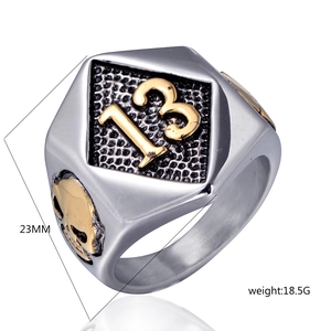 Detail of punk skull ring featuring gold number 13 emblem and intricate relief details