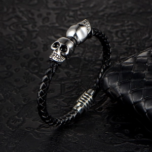 Handcrafted punk braided black leather bracelet with double silver skull charms and magnetic clasp