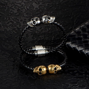 Double-layered woven leather bracelet with silver and gold stainless steel skull charms