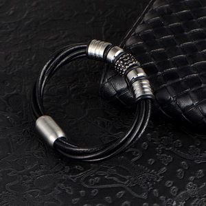 Men's multi-layer black braided leather bracelet with textured metal beads and magnetic clasp