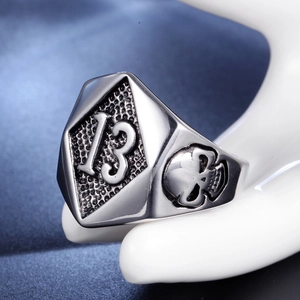 Macro shot of stainless steel biker ring with number 13 shield and skull carving